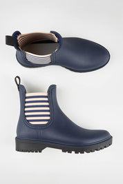 A model wearing size 37 of the Laurina2 Gumboot in colour Navystripe (Blue), from the front, showing the whole outfit