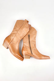 A model wearing size 37 of the Evren Leather Western Boot in colour Dktan, from the front, showing the whole outfit