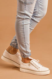 A model wearing size 37 of the Froggy Leather Sneaker in colour Whiteleath (White), from the front, cropped image