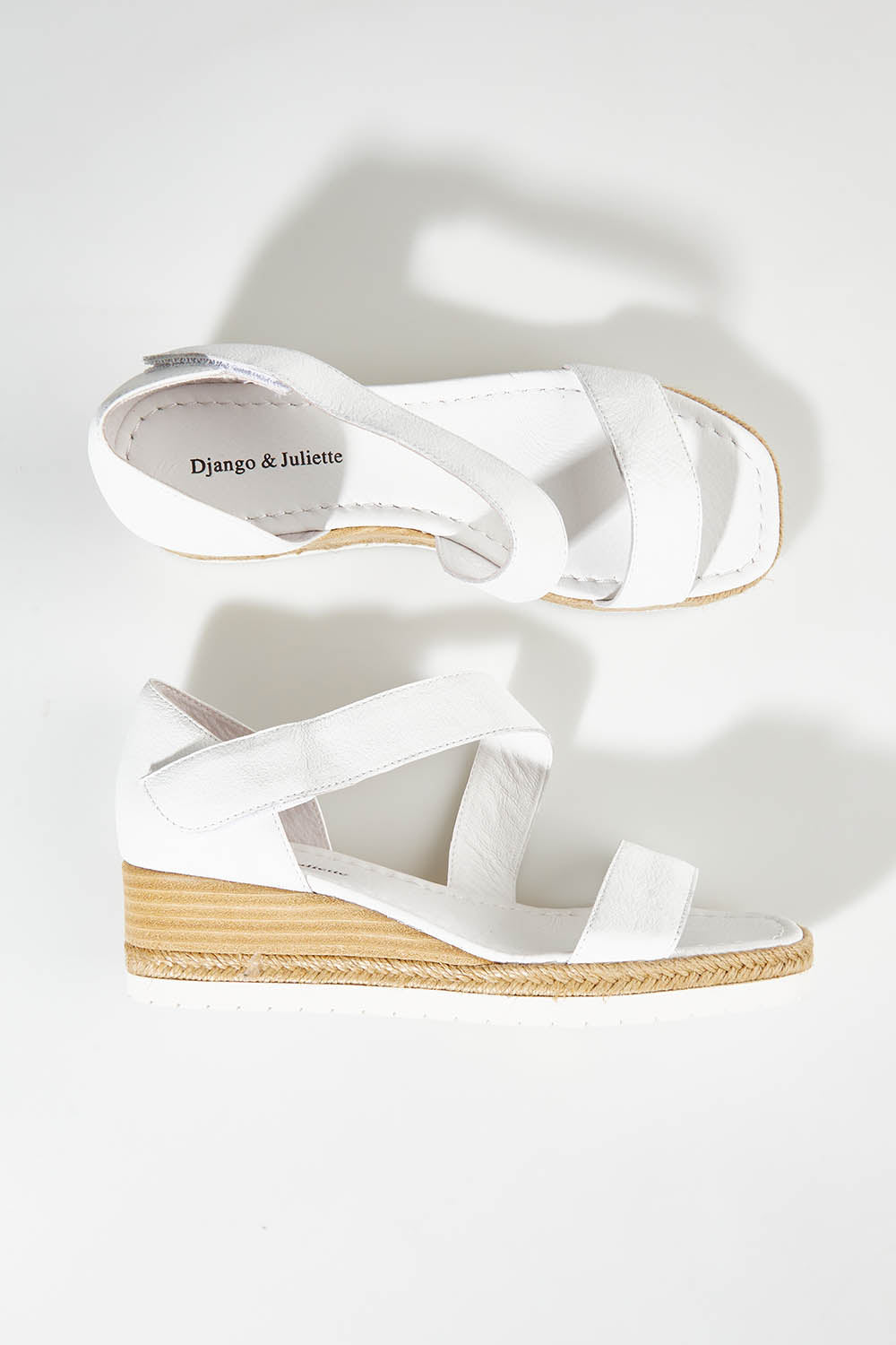 A model wearing size 37 of the Inori Leather Wedge in colour White (White), from the front, showing the whole outfit