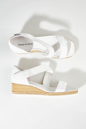 A model wearing size 37 of the Inori Leather Wedge in colour White (White), from the front, showing the whole outfit