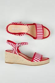 A model wearing size 37 of the Melodys Stripe Wedge in colour Redwhite (Red), from the front, showing the whole outfit