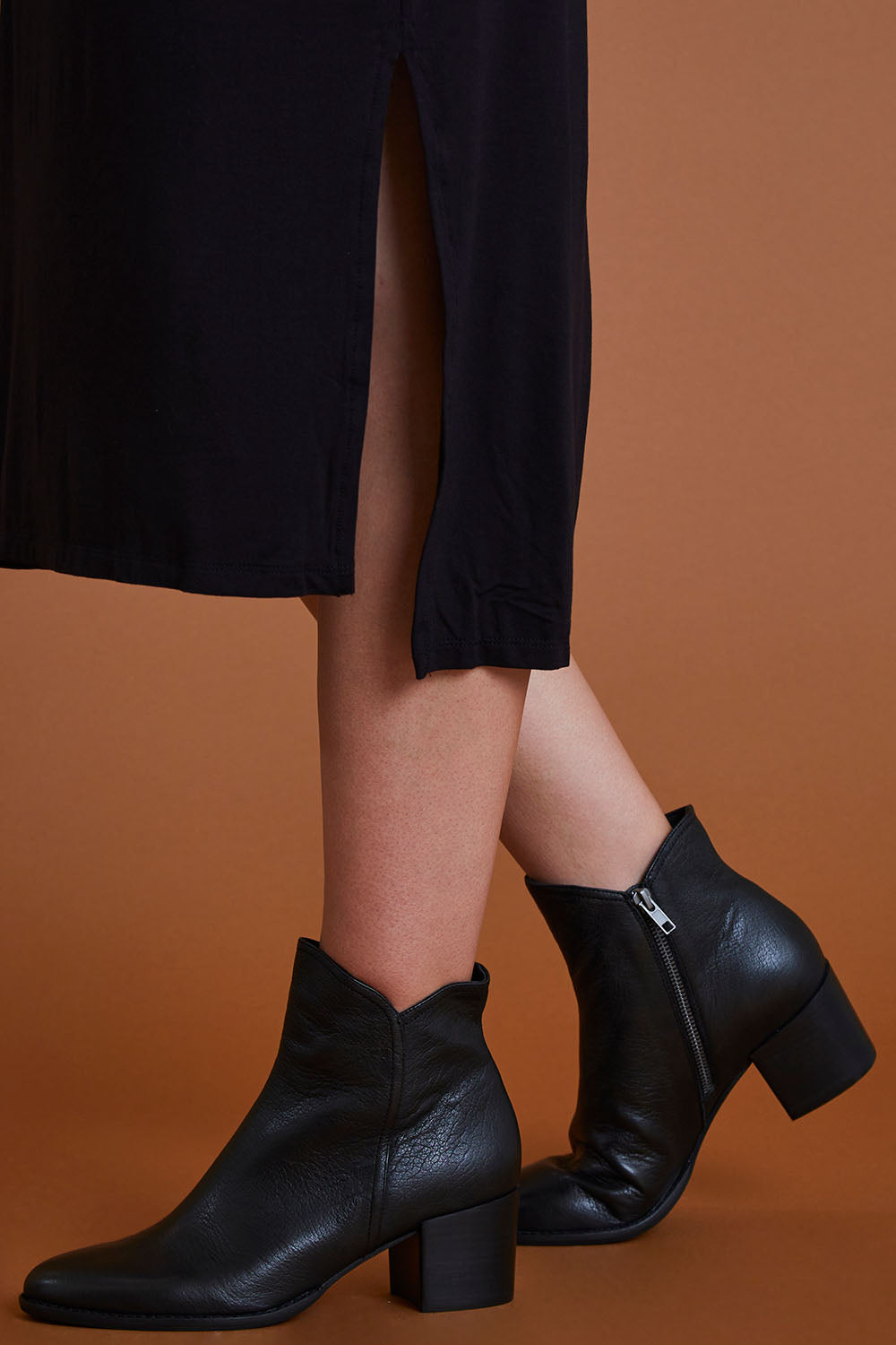 A model wearing size 40 of the Mockas Ankle Boot in colour BlackBlack (Black), from the front, cropped image