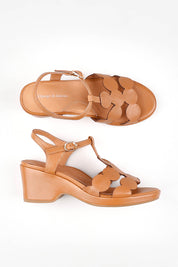 A model wearing size 37 of the Nayad Leather Heel in colour Darktan, from the front, showing the whole outfit