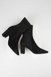 A model wearing size 37 of the Nider Stretch Heel Ankle Boot in colour Blackstret (Black), from the front, showing the whole outfit