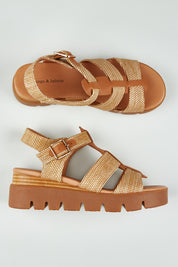 A model wearing size 37 of the Rhodesy Leather Wedge in colour Coffeedkta, from the front, showing the whole outfit