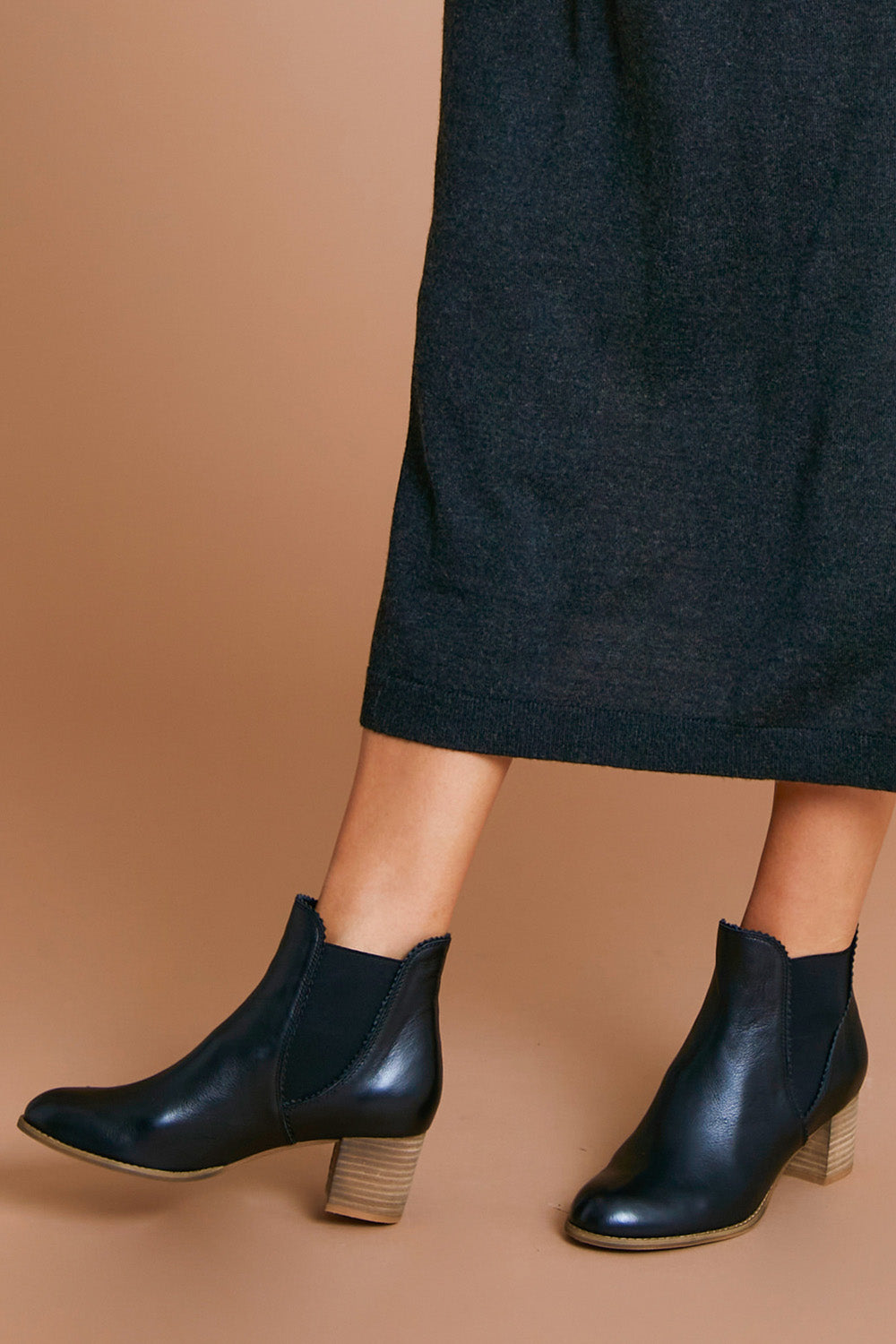 A model wearing size 38 of the Sadore Boot in colour Black (Black), from the front, cropped image
