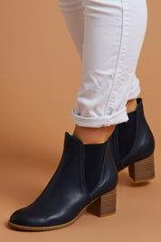 A model wearing size 38 of the Sadore Boot in colour Navy (Blue), from the front, showing the whole outfit