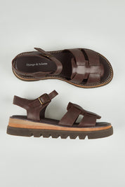A model wearing size 37 of the Simm Leather Flatform in colour Chocolate, from the front, showing the whole outfit