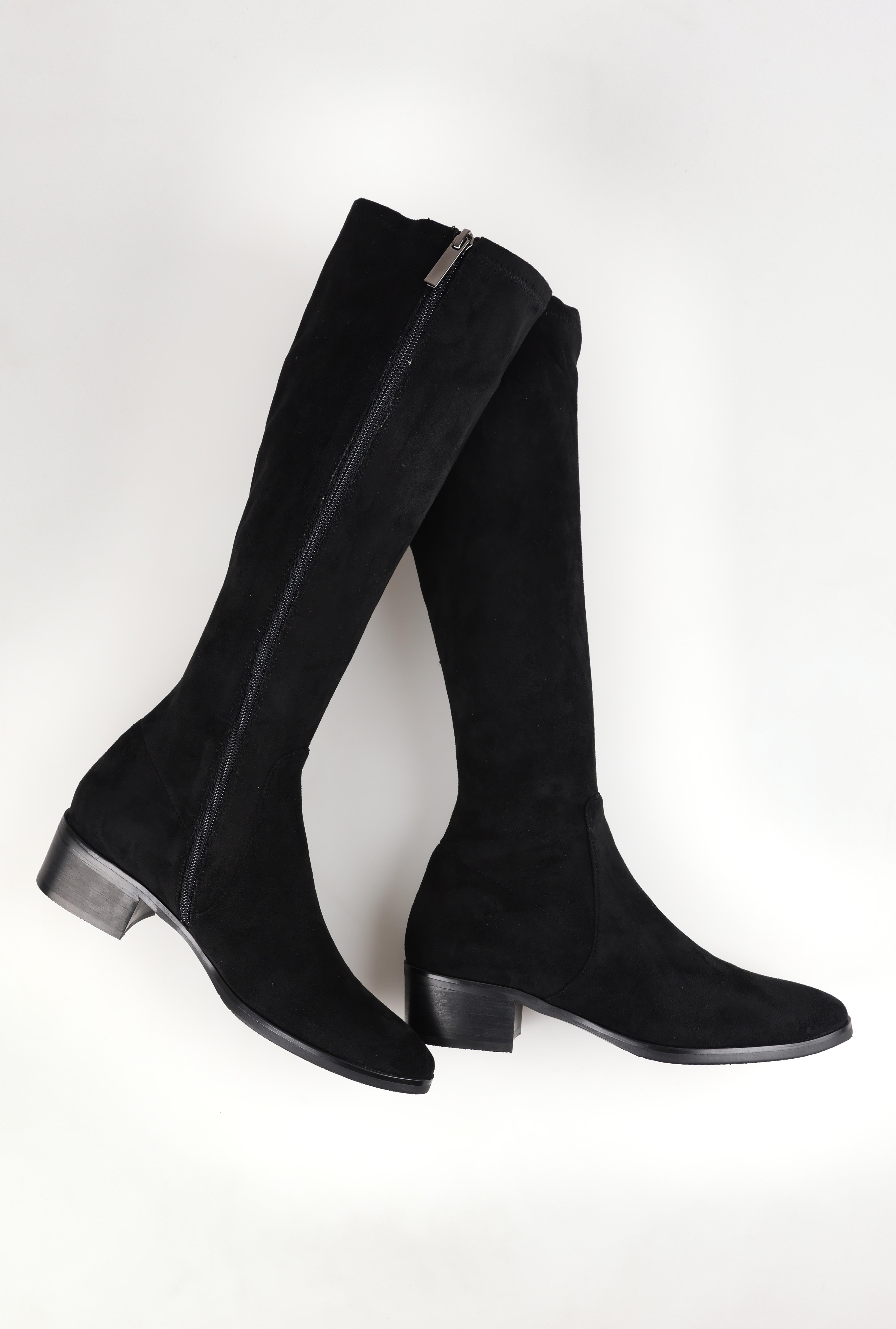A model wearing size 37 of the Timothie Microsuede Calf Boot in colour Blacksuede (Black), from the front, showing the whole outfit