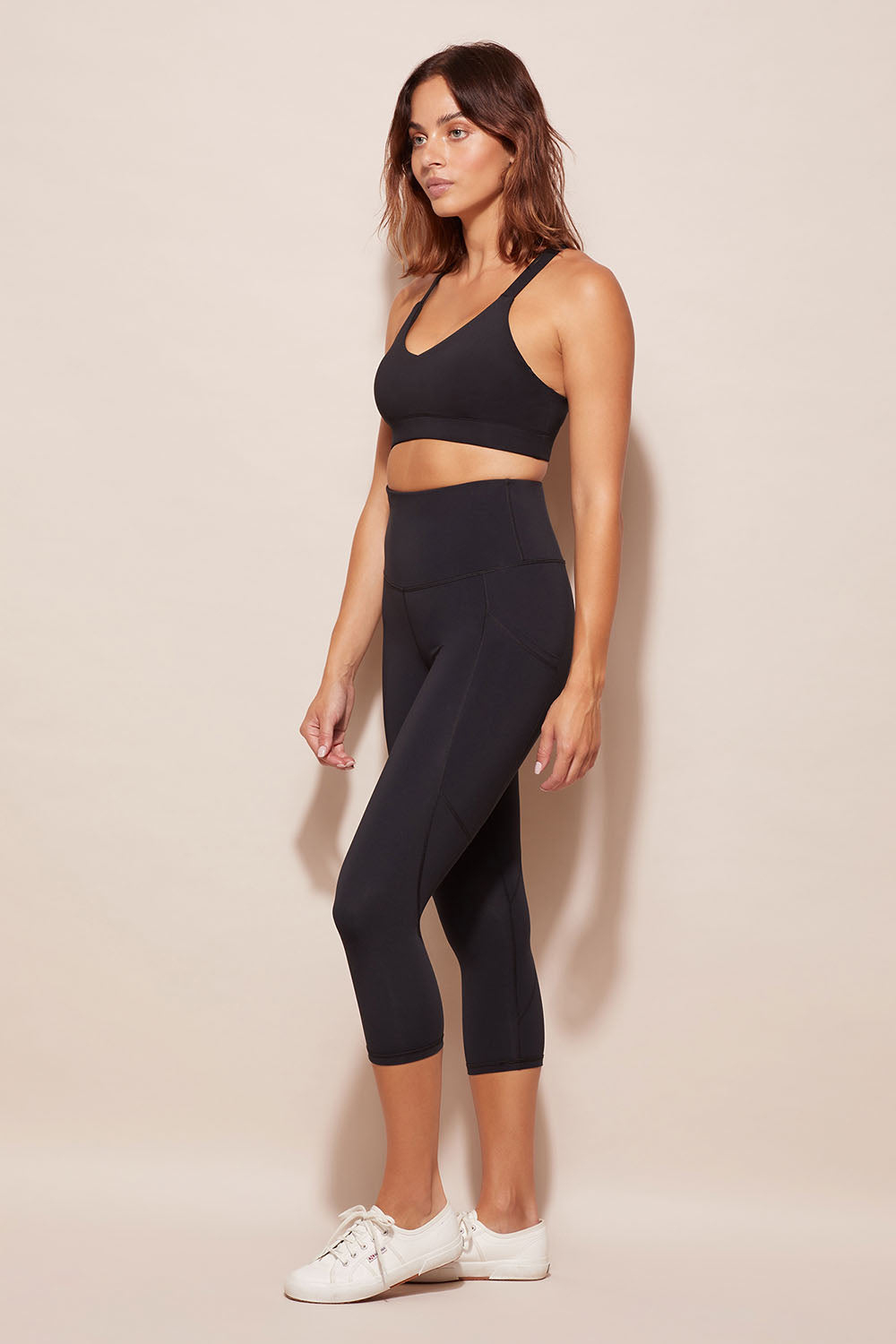 A model wearing the Essential Tight Midi in colour Black (Black), from the front, showing the whole outfit