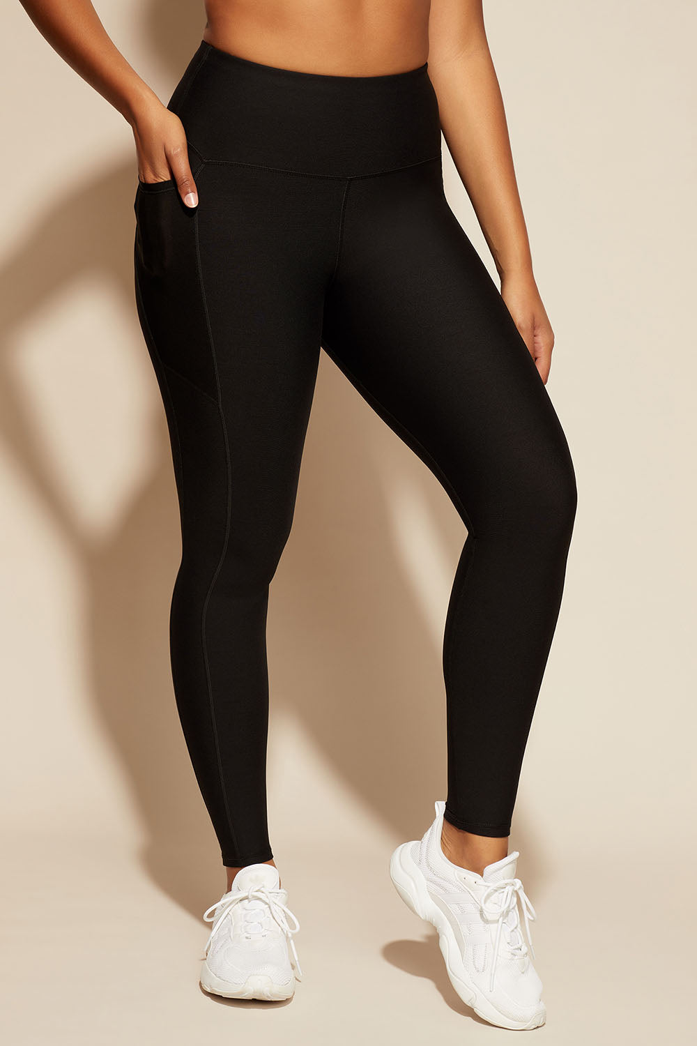 A model wearing the Elite Tight Full Length in colour Black (Black), from the front, cropped image