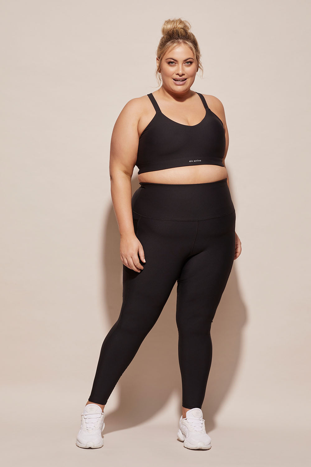 A model wearing the Elite Tight Full Length in colour Black (Black), from the front, showing the whole outfit