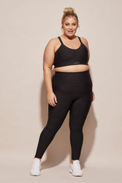 A model wearing the Elite Tight Full Length in colour Black (Black), from the front, showing the whole outfit