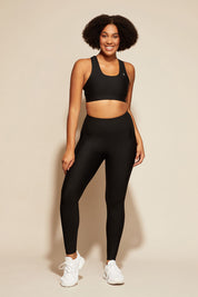 A model wearing the Elite Tight Full Length in colour Black (Black), from the front, showing the whole outfit