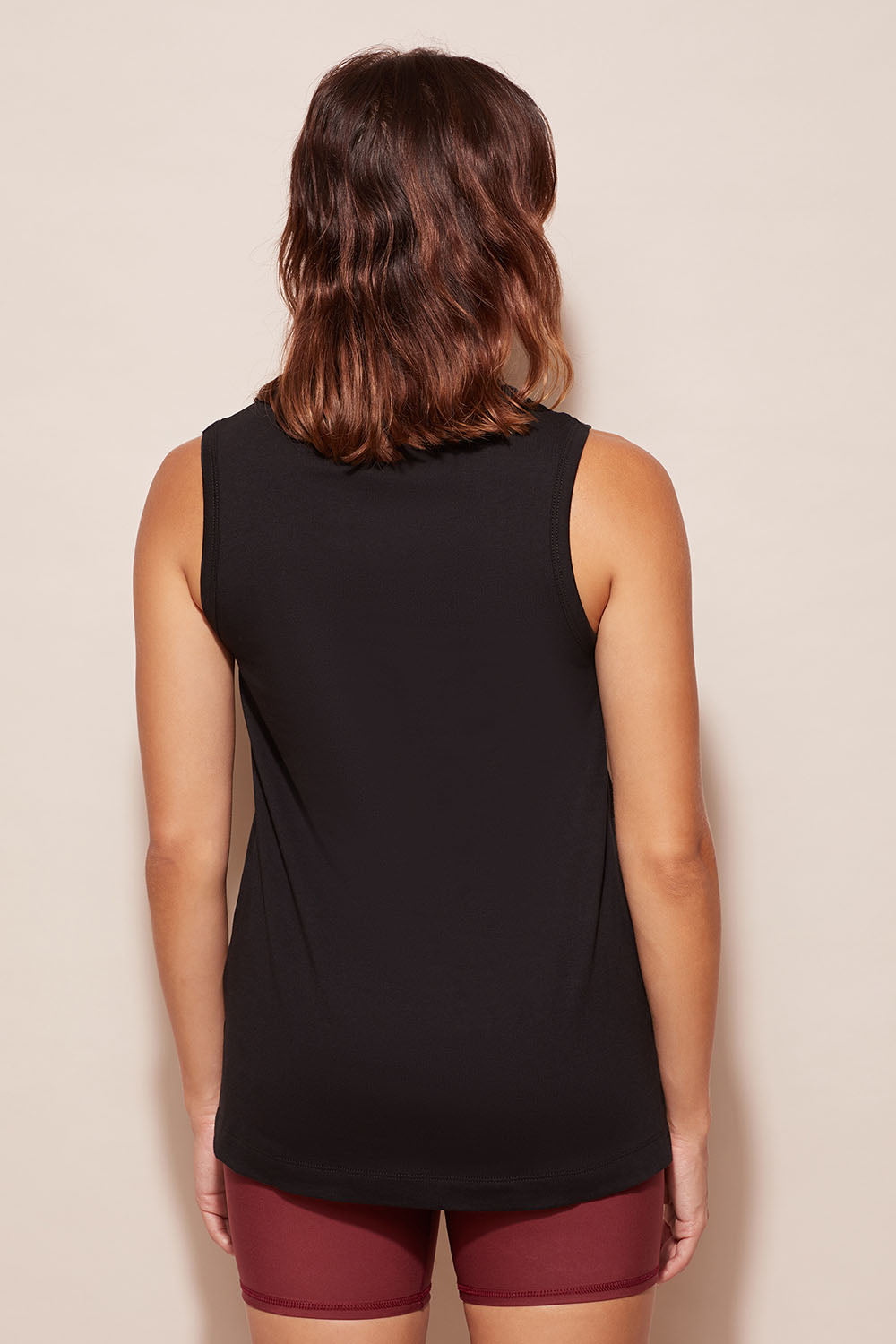 A model wearing the Champion Tank in colour Black (Black), from the back