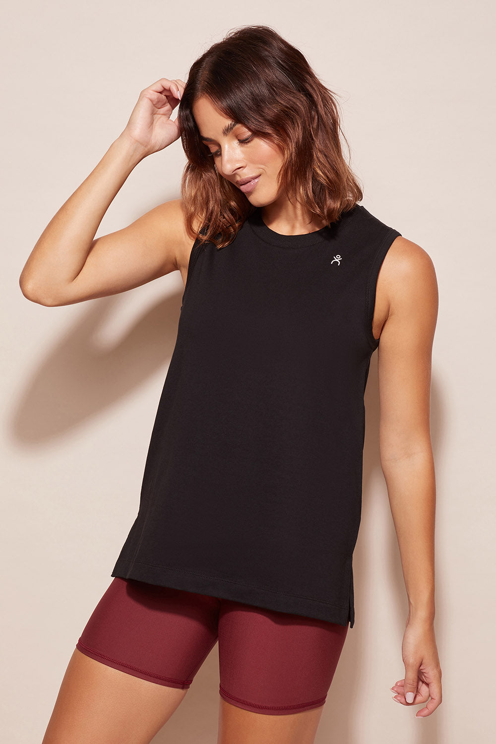A model wearing the Champion Tank in colour Black (Black), from the front, cropped image