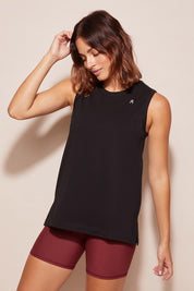 A model wearing the Champion Tank in colour Black (Black), from the front, cropped image
