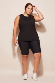 A model wearing the Champion Tank in colour Black (Black), from the front, showing the whole outfit