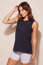 A model wearing the Champion Tank in colour Navy (Blue), from the front, cropped image