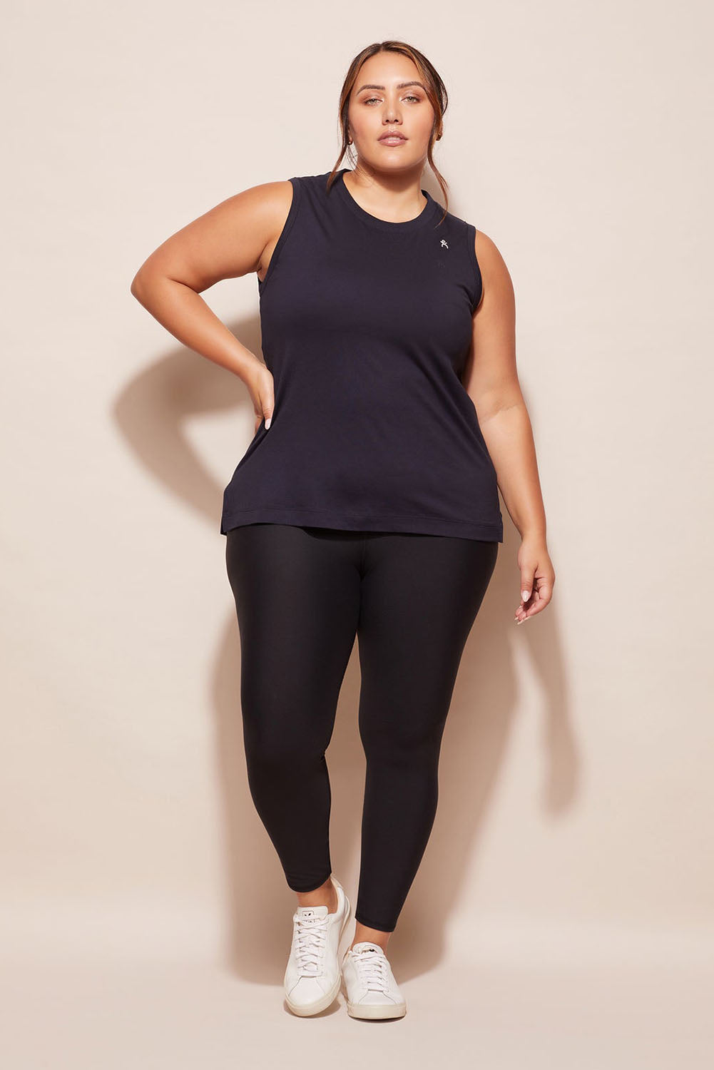 A model wearing the Champion Tank in colour Navy (Blue), from the front, showing the whole outfit