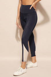 A model wearing the Turbulence Tight in colour Navypink (Blue), from the front, cropped image