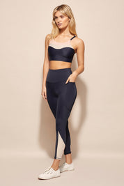 A model wearing the Turbulence Tight in colour Navypink (Blue), from the front, showing the whole outfit