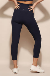 A model wearing the Harlow Ribbed Tight in colour Navy (Blue), from the back