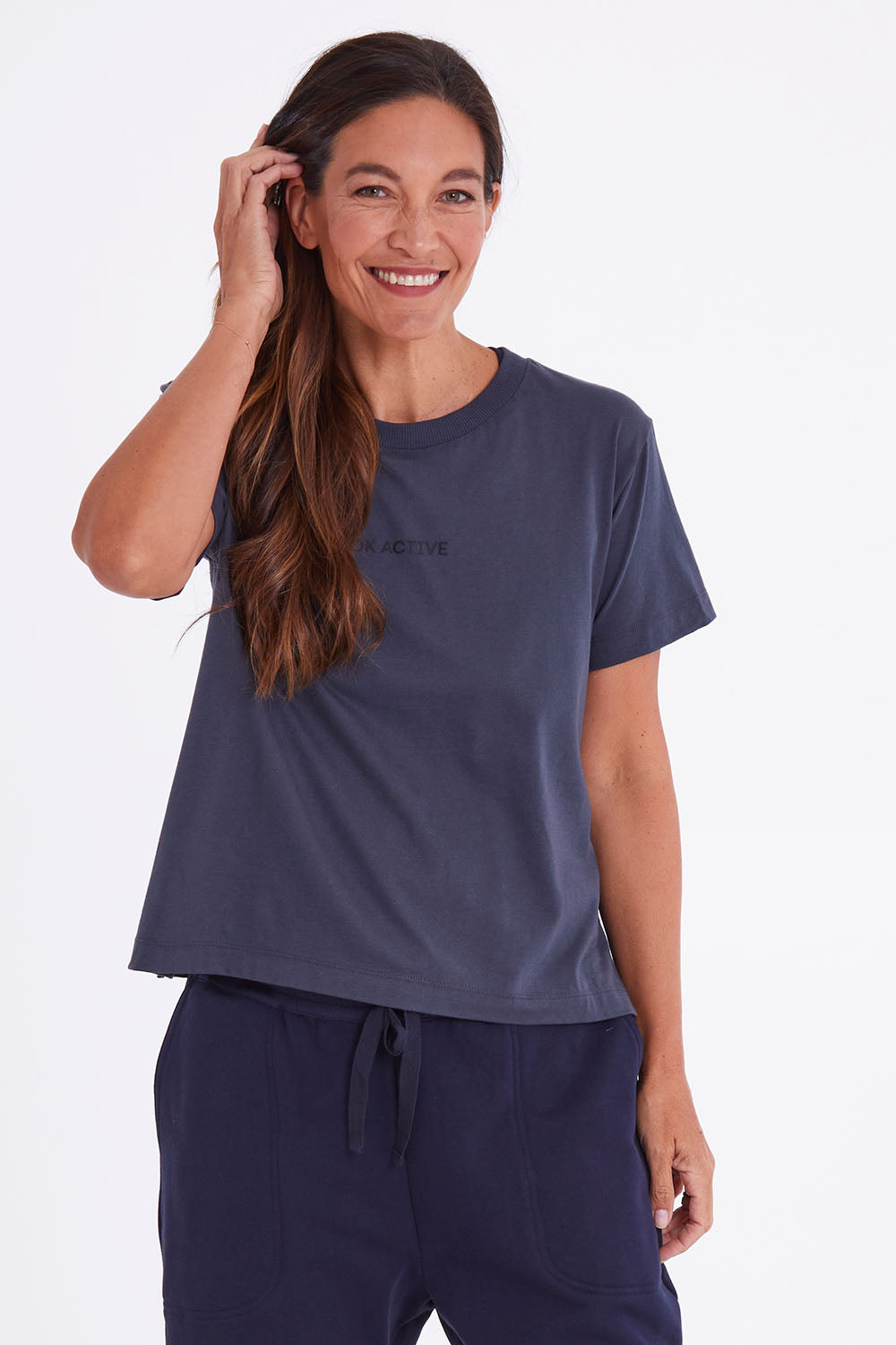 Model Alex wearing the Way Back Tee in colour Smoke (Grey), from the front, cropped image