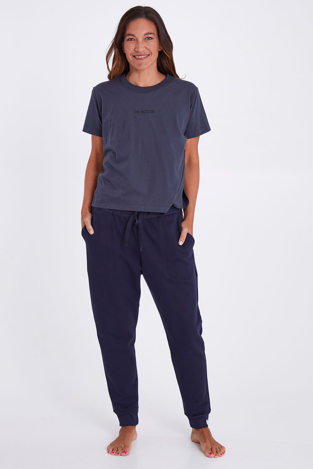 Model Alex wearing the Way Back Tee in colour Smoke (Grey), from the front, showing the whole outfit