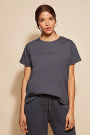 A model wearing the Way Back Tee in colour Smoke (Grey), from the front, cropped image