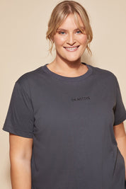 A model wearing the Way Back Tee in colour Smoke (Grey), from the front, cropped image