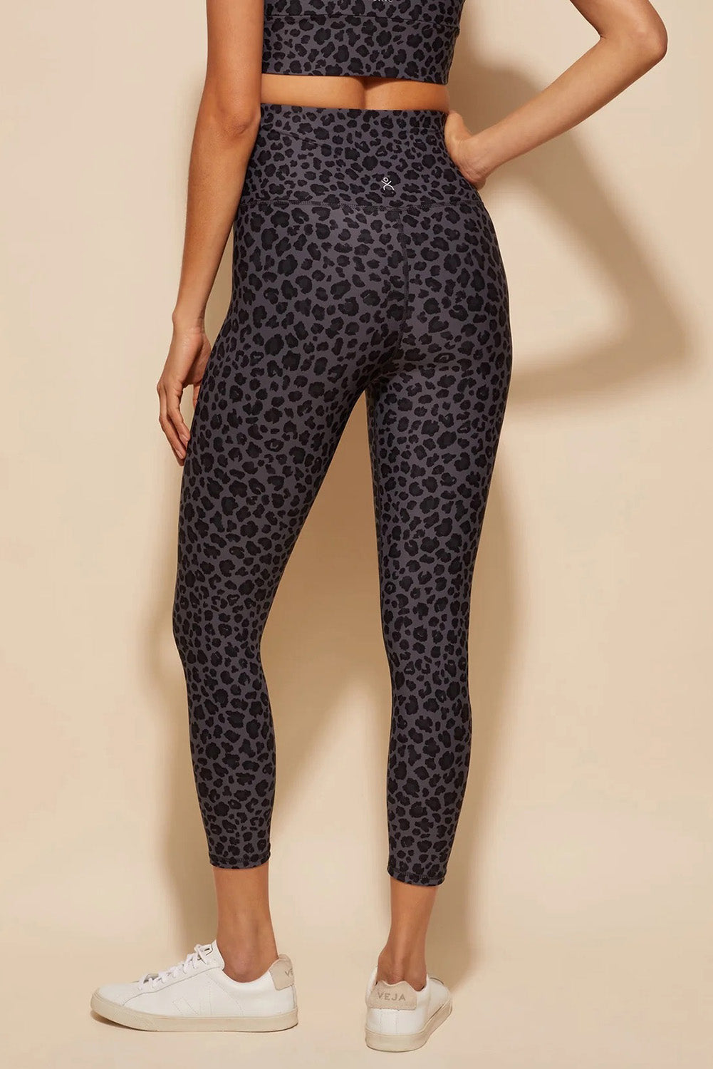 A model wearing the Utopia Tight in colour Leopardsmk (Grey), from the back