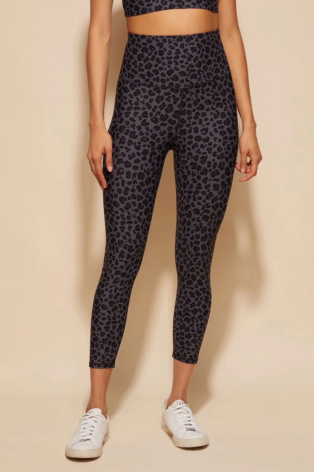 A model wearing the Utopia Tight in colour Leopardsmk (Grey), from the front, cropped image