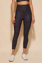 A model wearing the Utopia Tight in colour Leopardsmk (Grey), from the front, cropped image