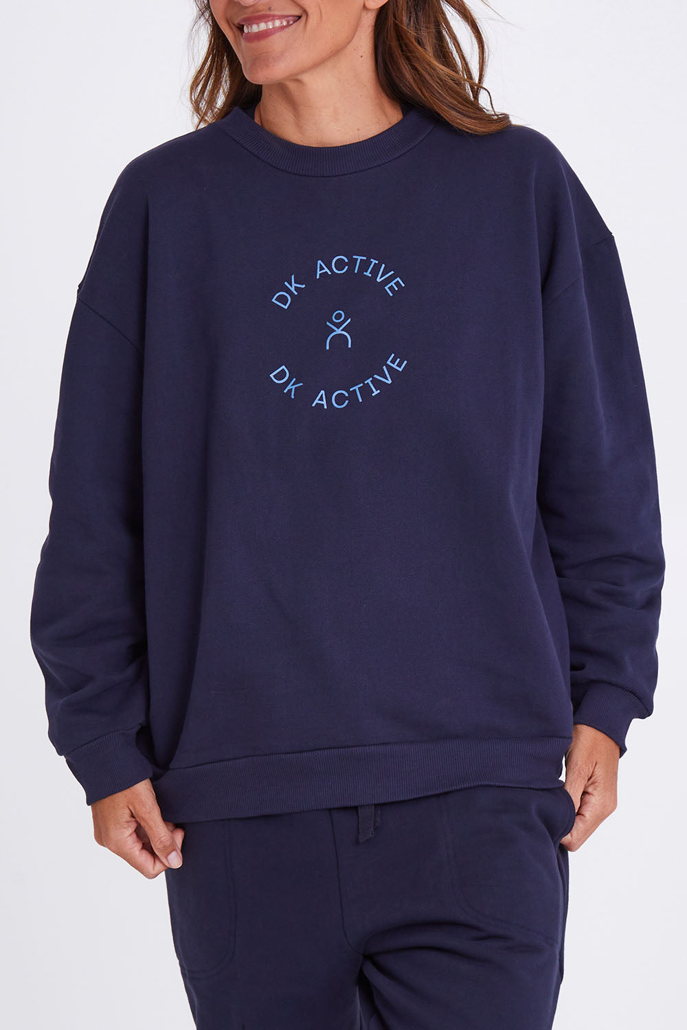 Model Alex wearing the Sonny Jumper in colour Navy (Blue), from the front, cropped image