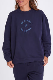 Model Alex wearing the Sonny Jumper in colour Navy (Blue), from the front, cropped image