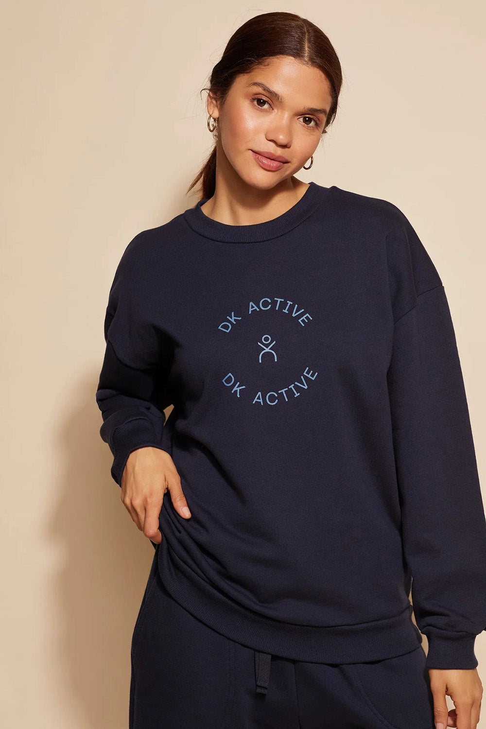 A model wearing the Sonny Jumper in colour Navy (Blue), from the front, cropped image