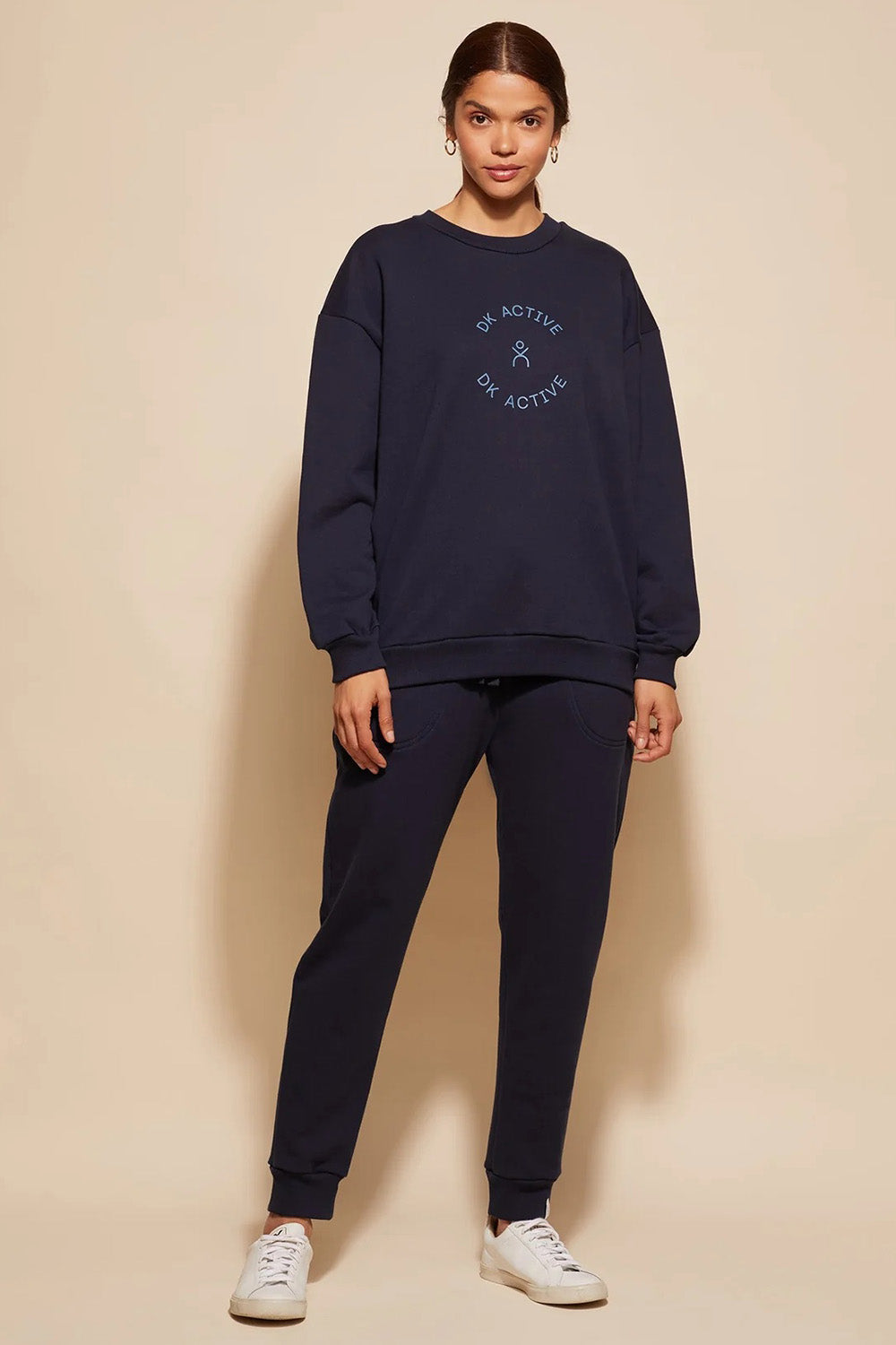A model wearing the Sonny Jumper in colour Navy (Blue), from the front, showing the whole outfit