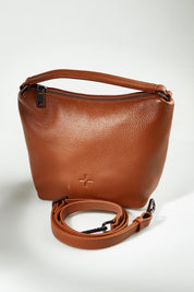 A model wearing the Addison Multiway Leather Bag in colour Tan, from the front, showing the whole outfit