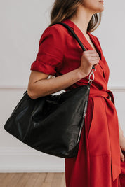 A model wearing the Adele Large Leather Bag in colour Black (Black), from the front, showing the whole outfit