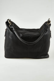 A model wearing the Adele Large Leather Bag in colour Black (Black), from the front, showing the whole outfit