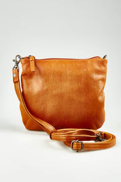 A model wearing size OneSize of the Castle In The Sky Leather Bag in colour Tan, from the front, showing the whole outfit