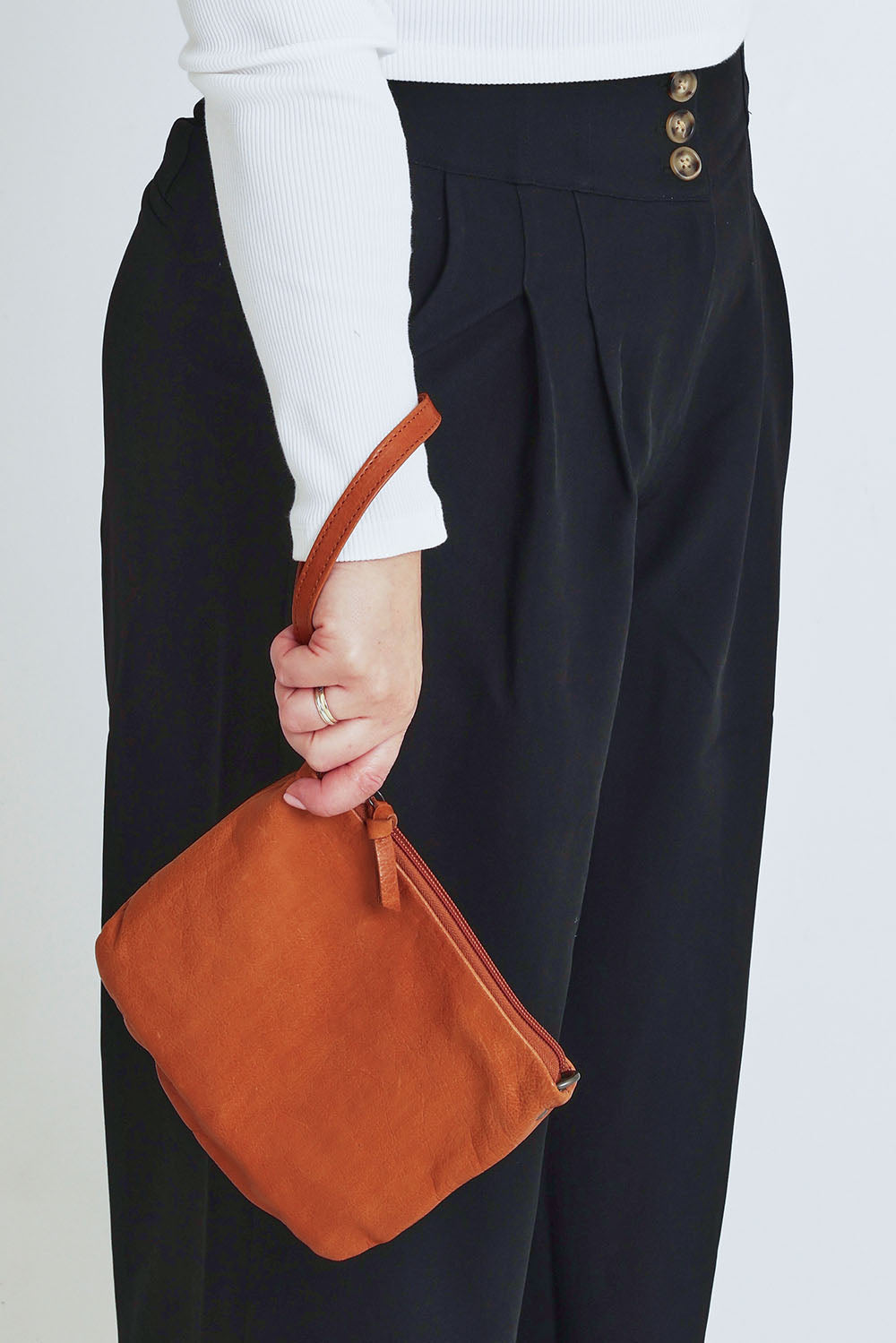 Model Steph wearing size OneSize of the Castle In The Sky Leather Bag in colour Tan, from the front, cropped image