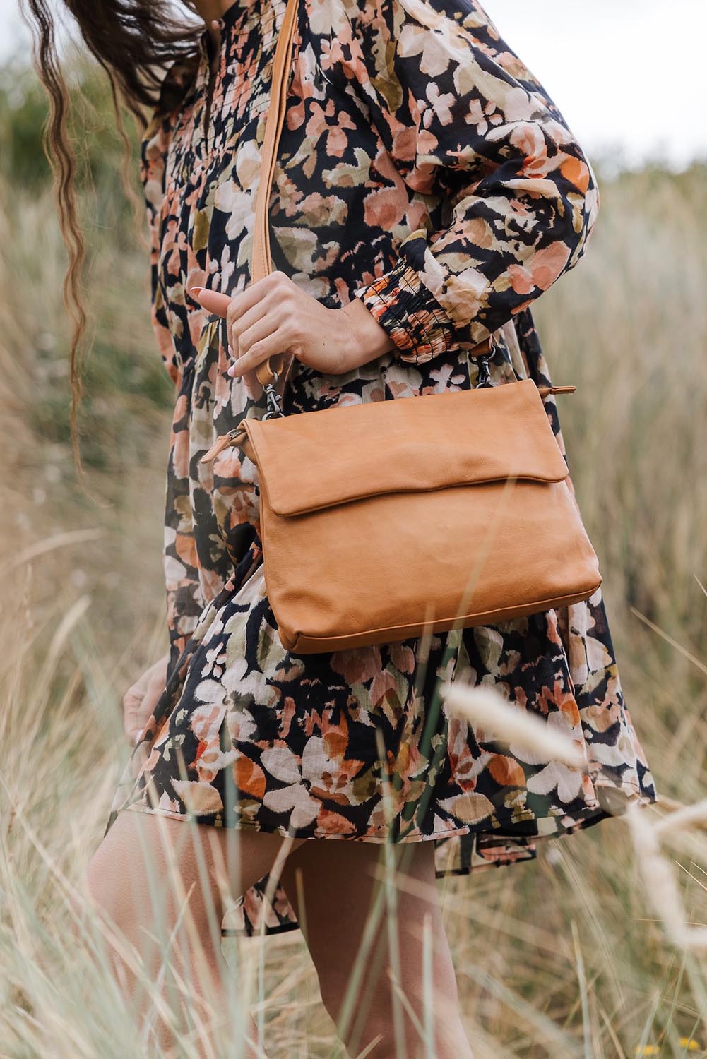 A model wearing the Delphi Leather Bag in colour Tan, from the front, showing the whole outfit