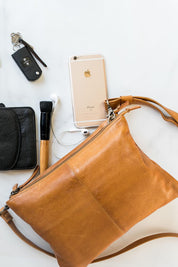 A model wearing the Ellie Leather Bag in colour Tan, from the front, showing the whole outfit