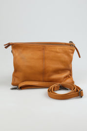A model wearing the Ellie Leather Bag in colour Tan, from the front, showing the whole outfit