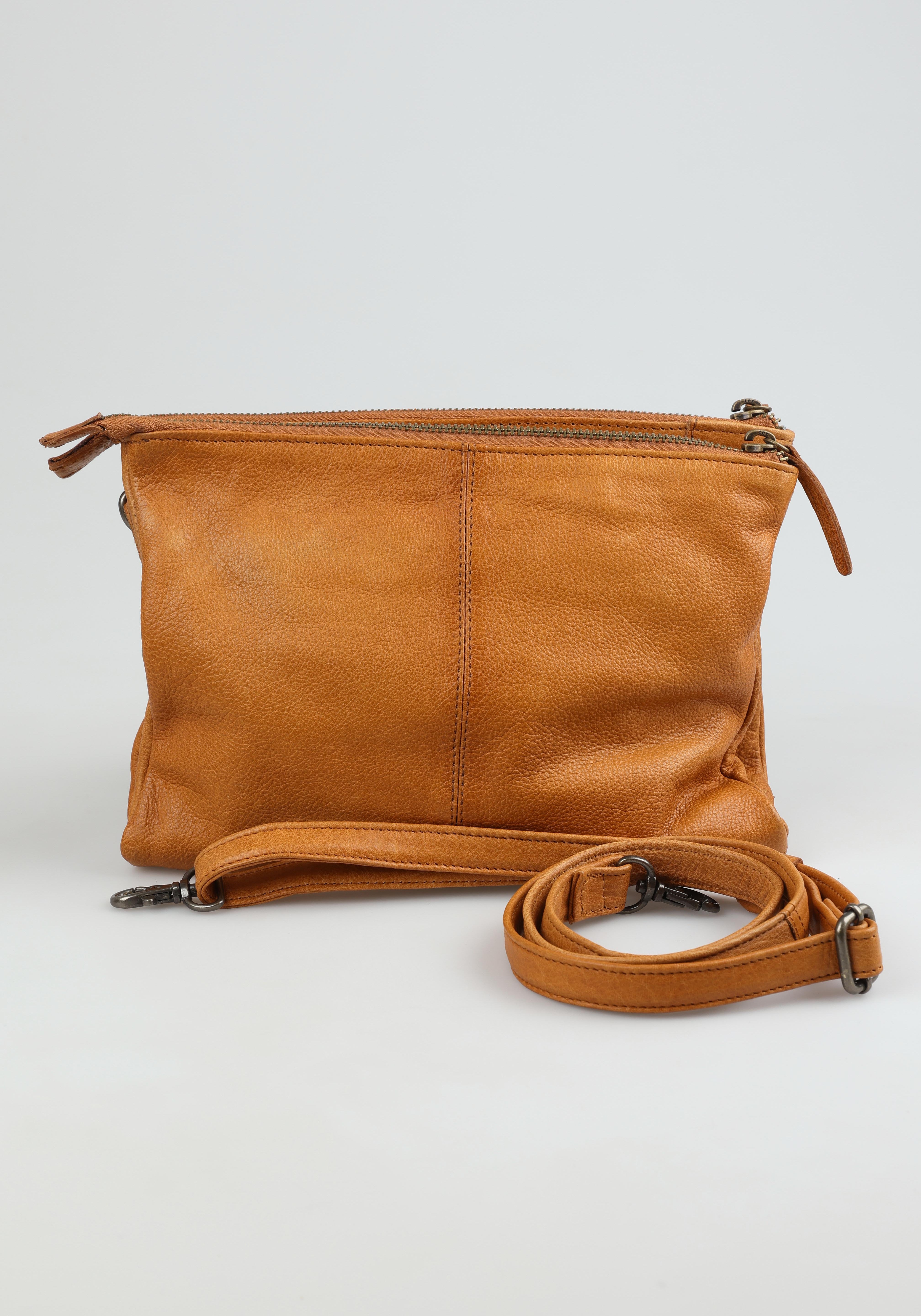 A model wearing the Ellie Leather Bag in colour Tan, from the front, showing the whole outfit