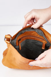 A model wearing size OneSize of the Grace Leather Bag in colour Tan, from the front, showing the whole outfit