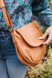 A model wearing the Grace Leather Bag in colour Tan, from the front, showing the whole outfit